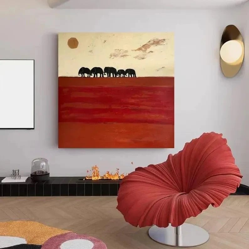 a modern living room with a large abstract painting of elephants on the wall, a red chair, and a fireplace.