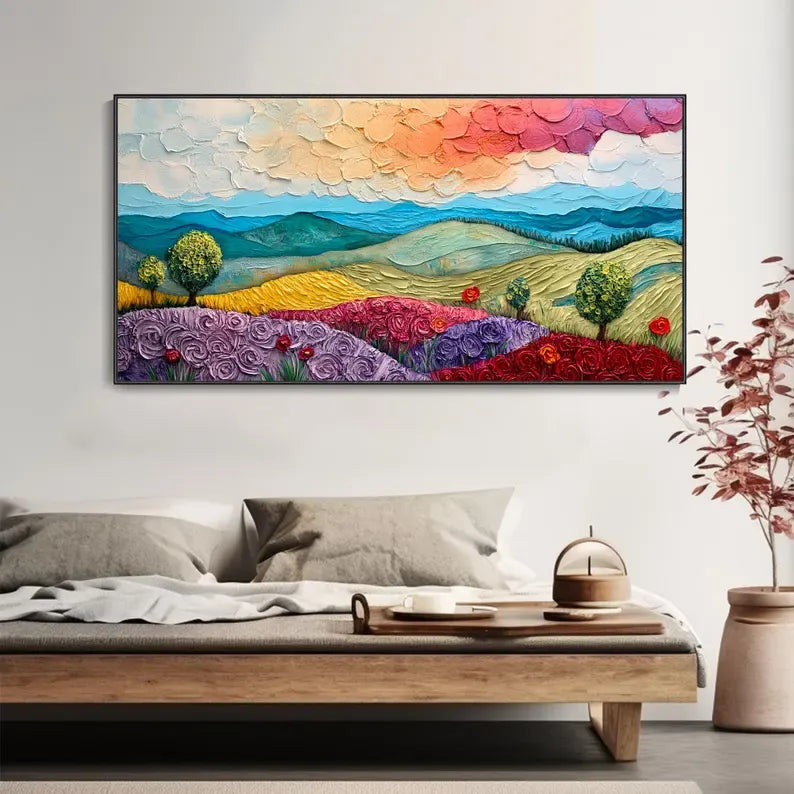 a large, colorful painting of a landscape with mountains, flowers, and trees hanging on a wall above a wooden coffee table.