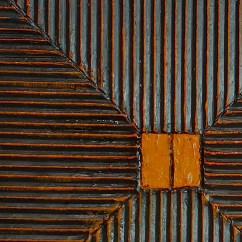 a close-up view of a textured surface with a repeating pattern of vertical and horizontal lines in shades of orange and black.