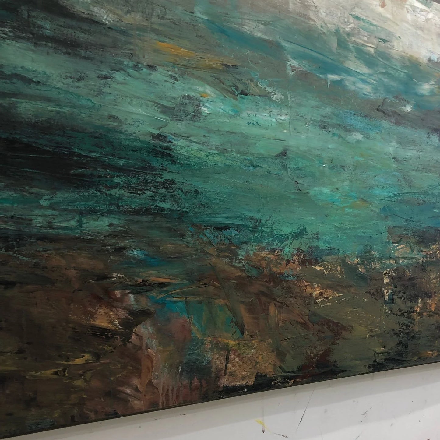 The image is a large abstract painting with a mix of dark and light colors, depicting a landscape scene with a blend of earthy tones and vibrant hues.