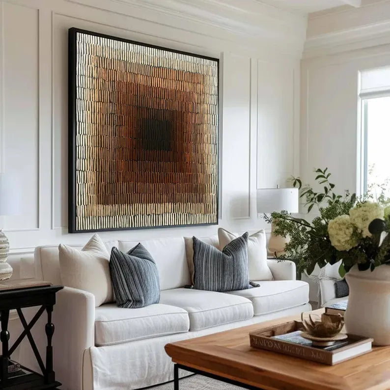 a modern living room with a large abstract painting on the wall, a white sofa with striped throw pillows, and a wooden coffee table with a vase of flowers.