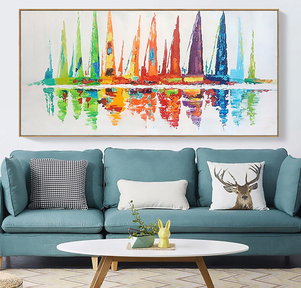 a living room with a blue couch and a painting on the wall
