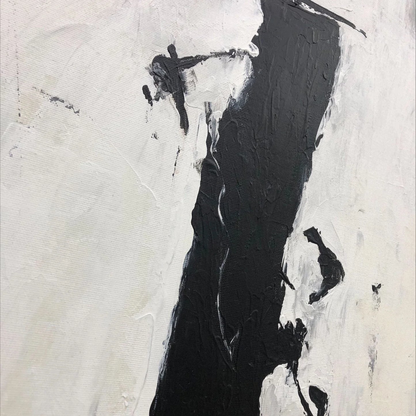The image is an abstract painting with bold black and white brushstrokes. The painting features a stark contrast between the two colors, creating a visually striking composition.