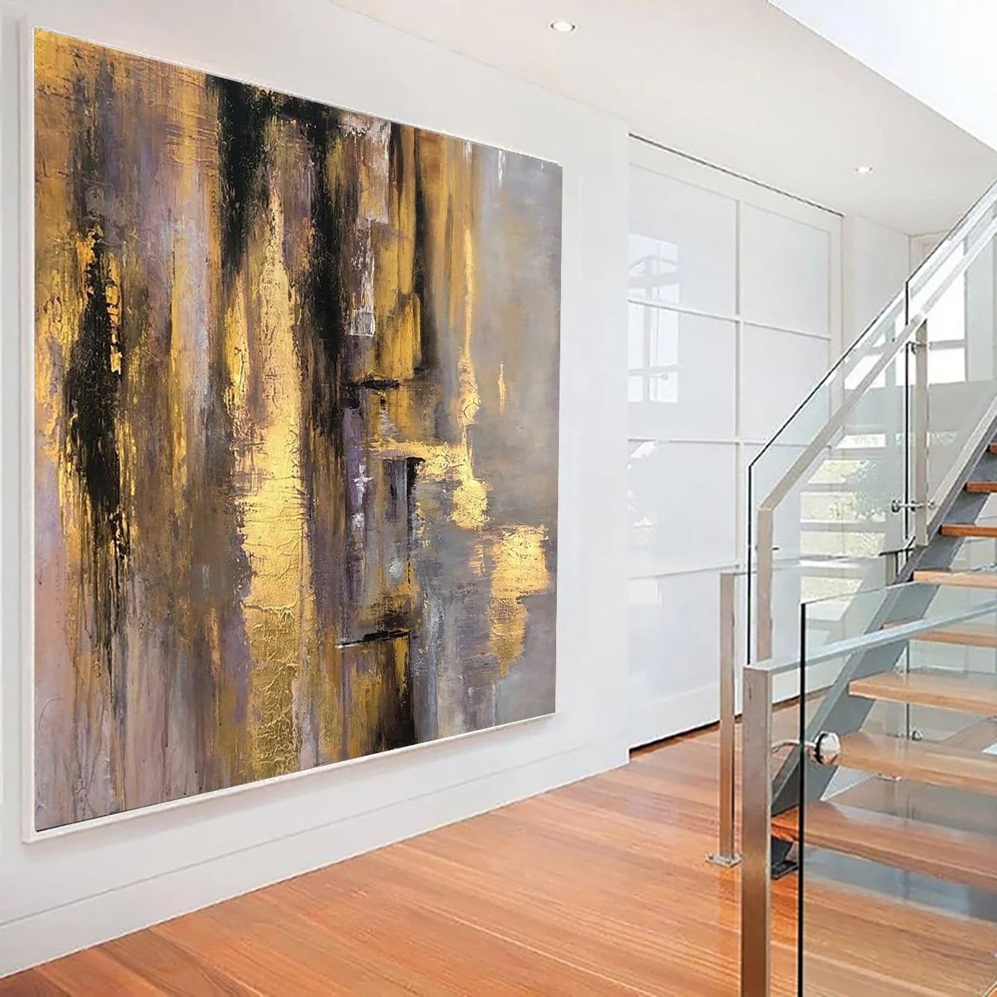 a large abstract painting hanging on a white wall, with a glass staircase visible in the background.