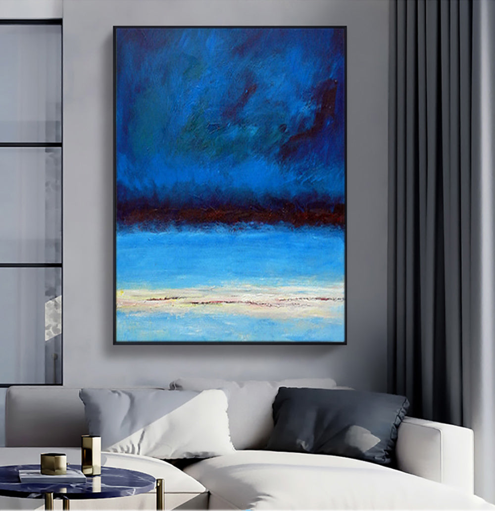 a living room with a couch and a painting on the wall