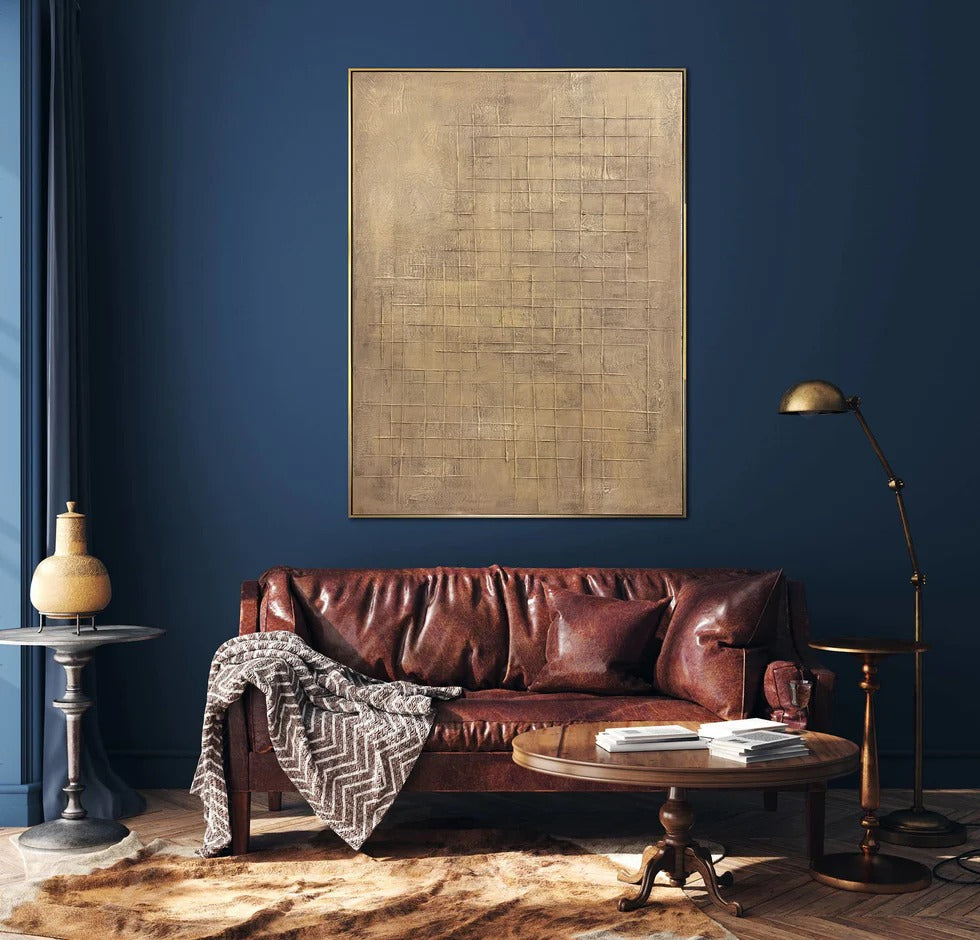 a cozy living room with a brown leather sofa, a wooden coffee table, and a large abstract painting on the wall.