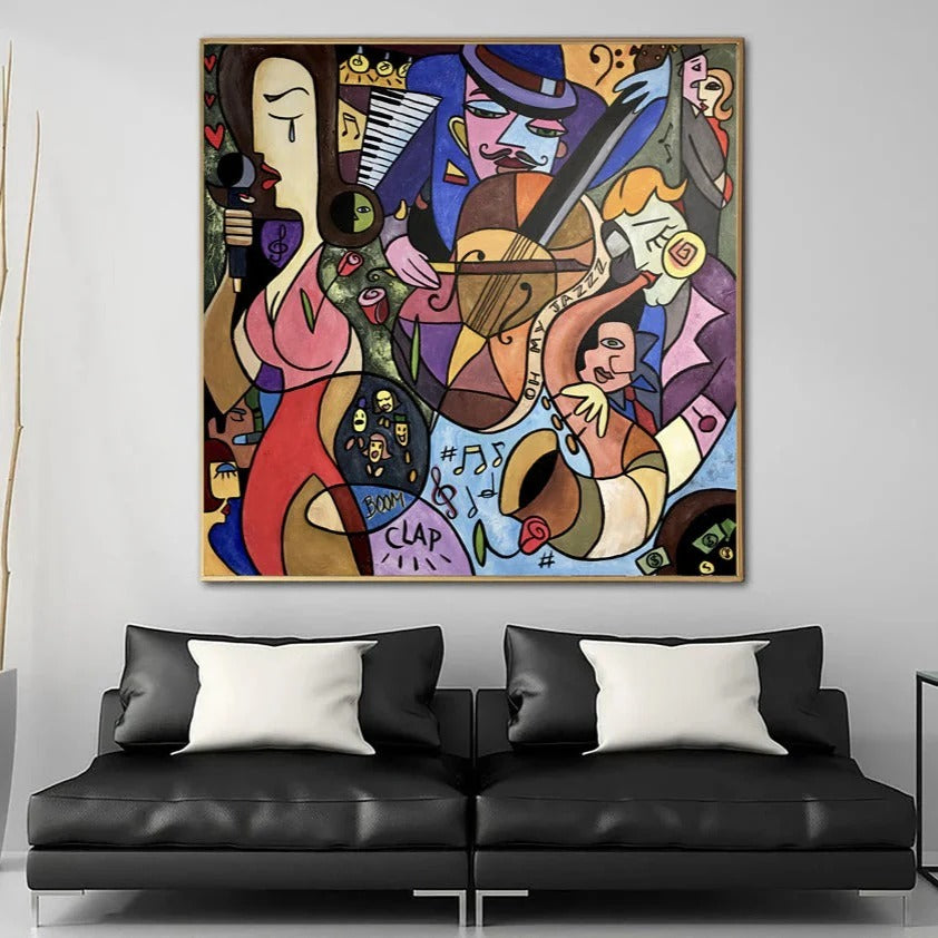 a vibrant, abstract painting hanging on a wall above a black leather couch.