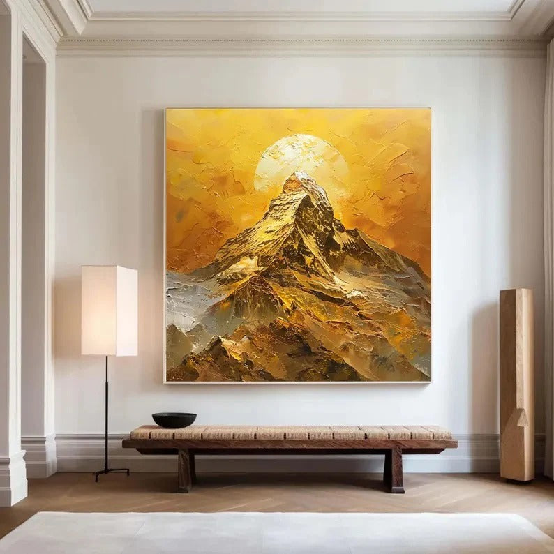 a large, vibrant painting of a mountain landscape with a sun in the background, hanging on a wall in a room with a wooden bench and a lamp.