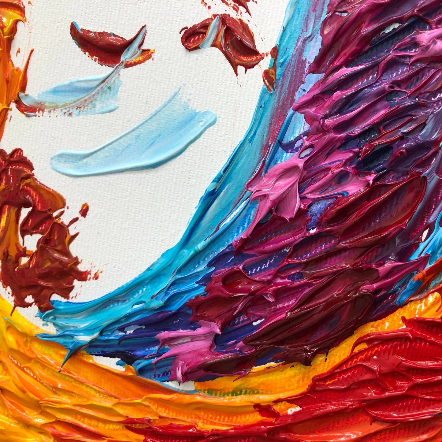 The image is a vibrant abstract painting featuring bold strokes of red, blue, and yellow paint on a white background. The painting has a dynamic and energetic feel, with the colors and brushstrokes creating a sense of movement and emotion.