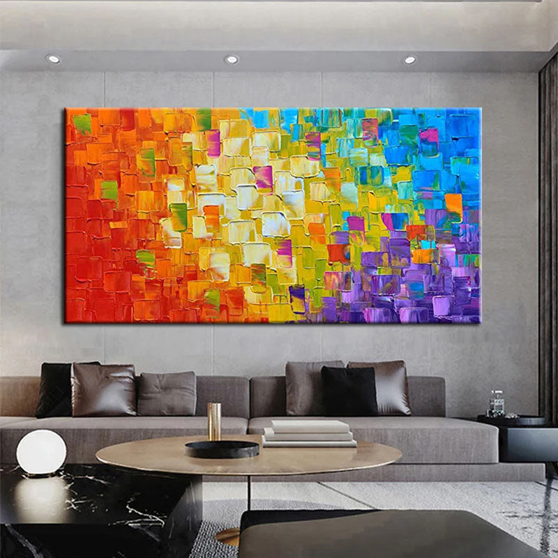 a living room with a couch and a painting on the wall