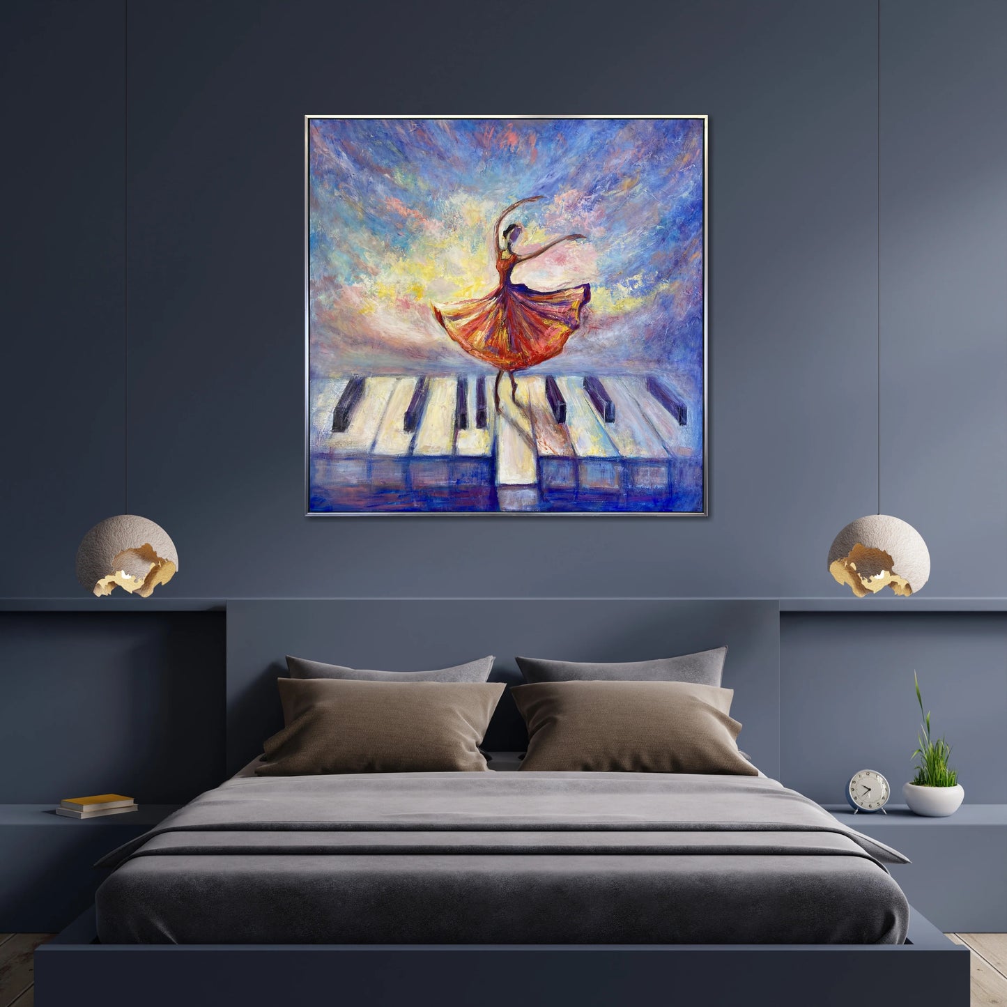 a large painting of a dancing woman on a piano keyboard, hanging above a bed with a gray bedspread and pillows.