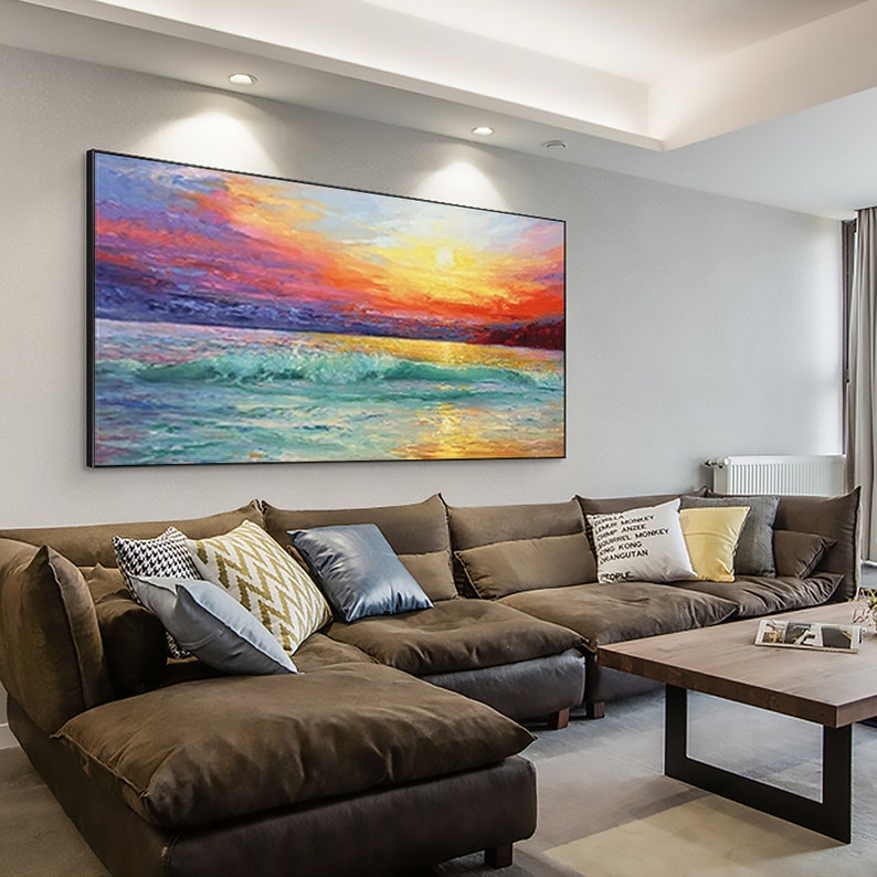 a living room filled with furniture and a painting on the wall