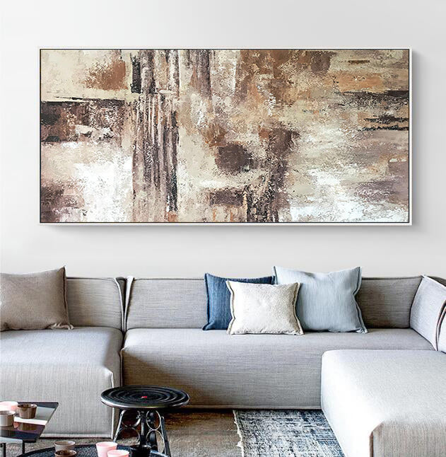 a living room with a couch and a painting on the wall