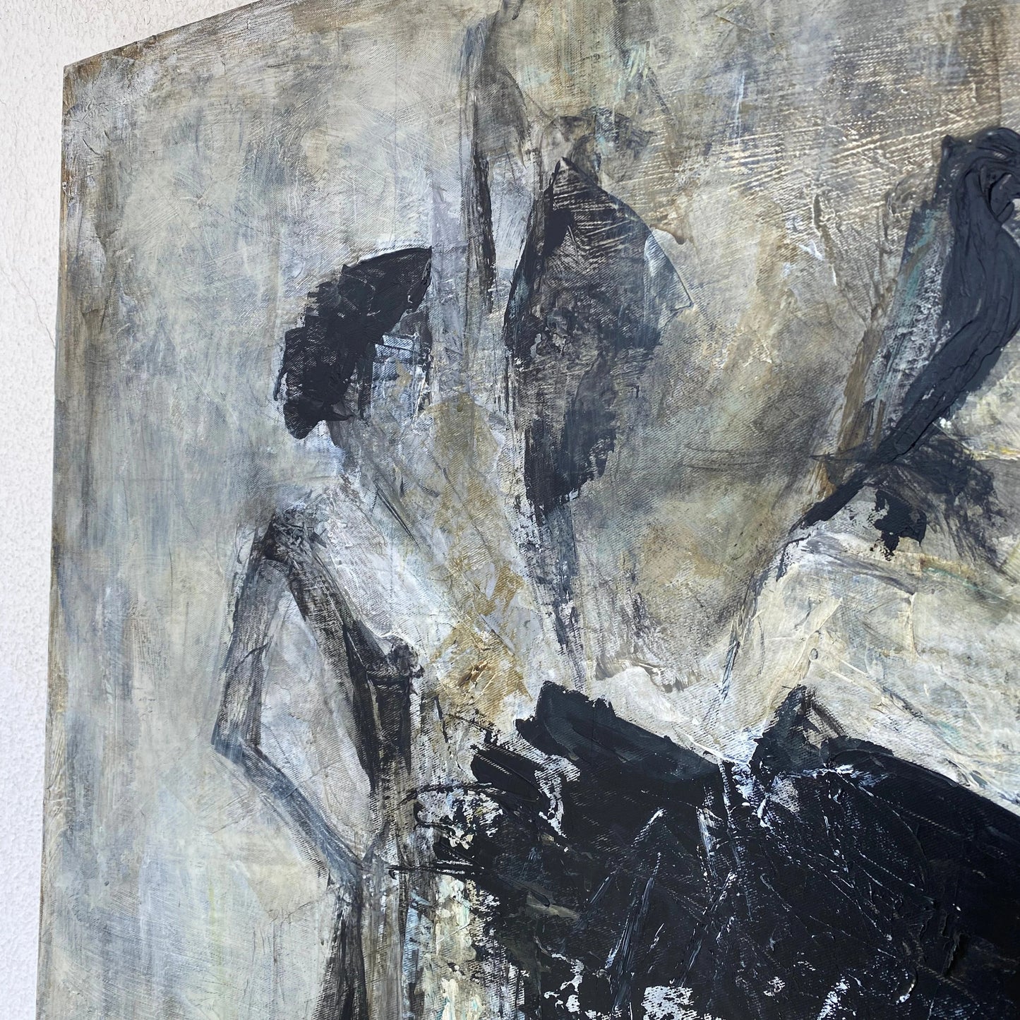 The image is an abstract painting with a mix of black, white, and gray colors. The painting features a large, dark shape in the center, surrounded by smaller shapes and lines that create a sense of depth and movement. The overall composition is dynamic and visually striking.