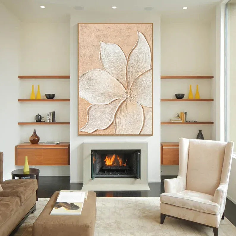 a modern living room with a fireplace, a large floral artwork on the wall, and a comfortable seating arrangement with a sofa and armchair.