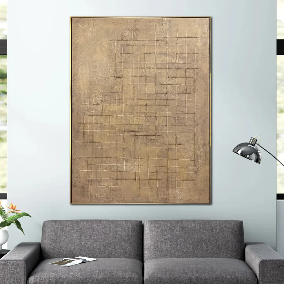 a large abstract painting hanging on a wall above a gray sofa in a living room setting.