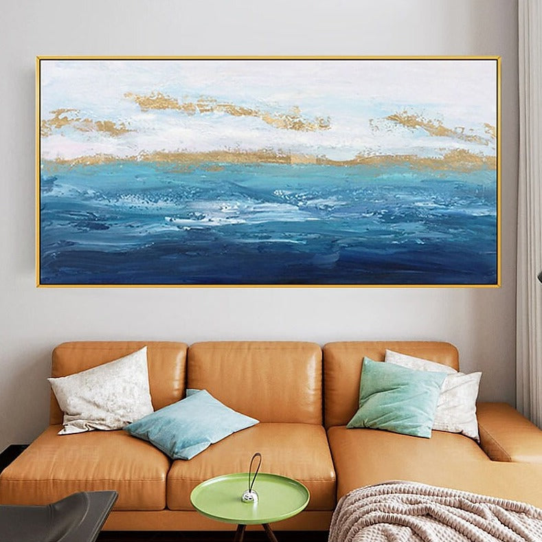 a living room with a couch and a painting on the wall