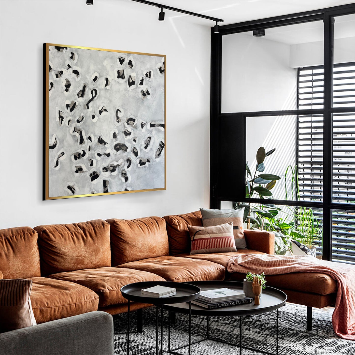 a living room filled with furniture and a large painting on the wall