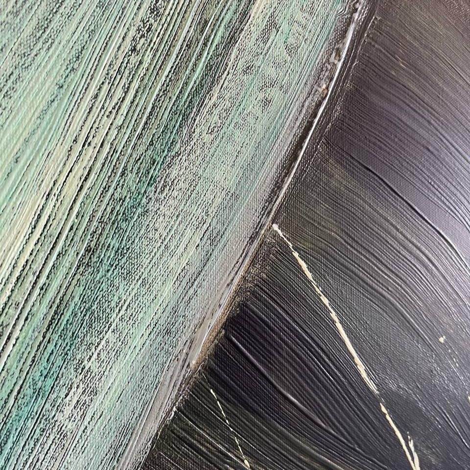 The image is a close-up of a textured surface with a mix of green and black colors, creating a visually striking contrast.