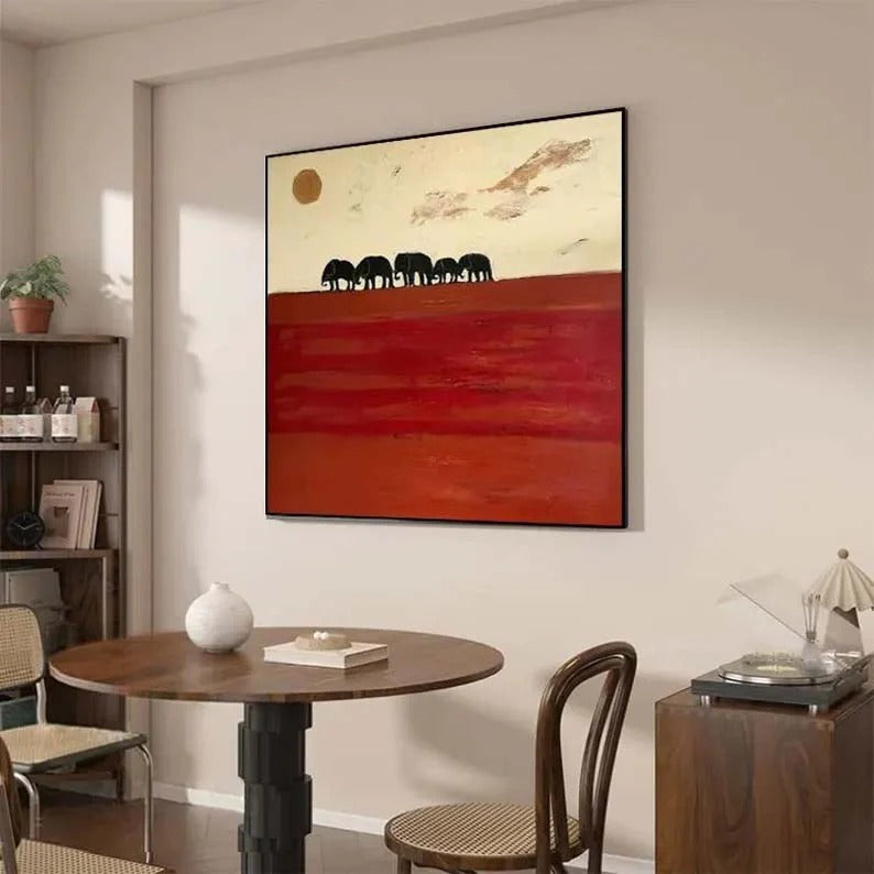 a large abstract painting hanging on a wall above a wooden dining table with chairs.