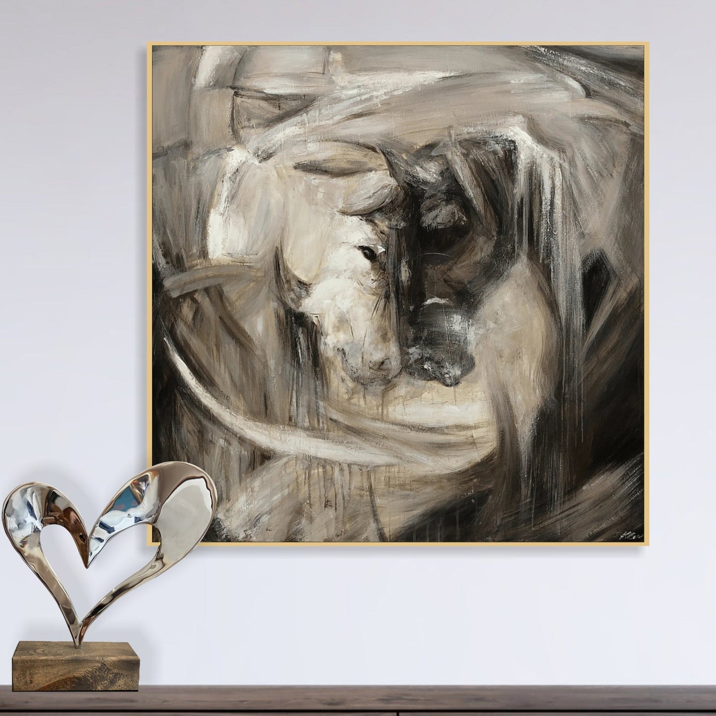 a painting on a wall with a heart shaped object in front of it