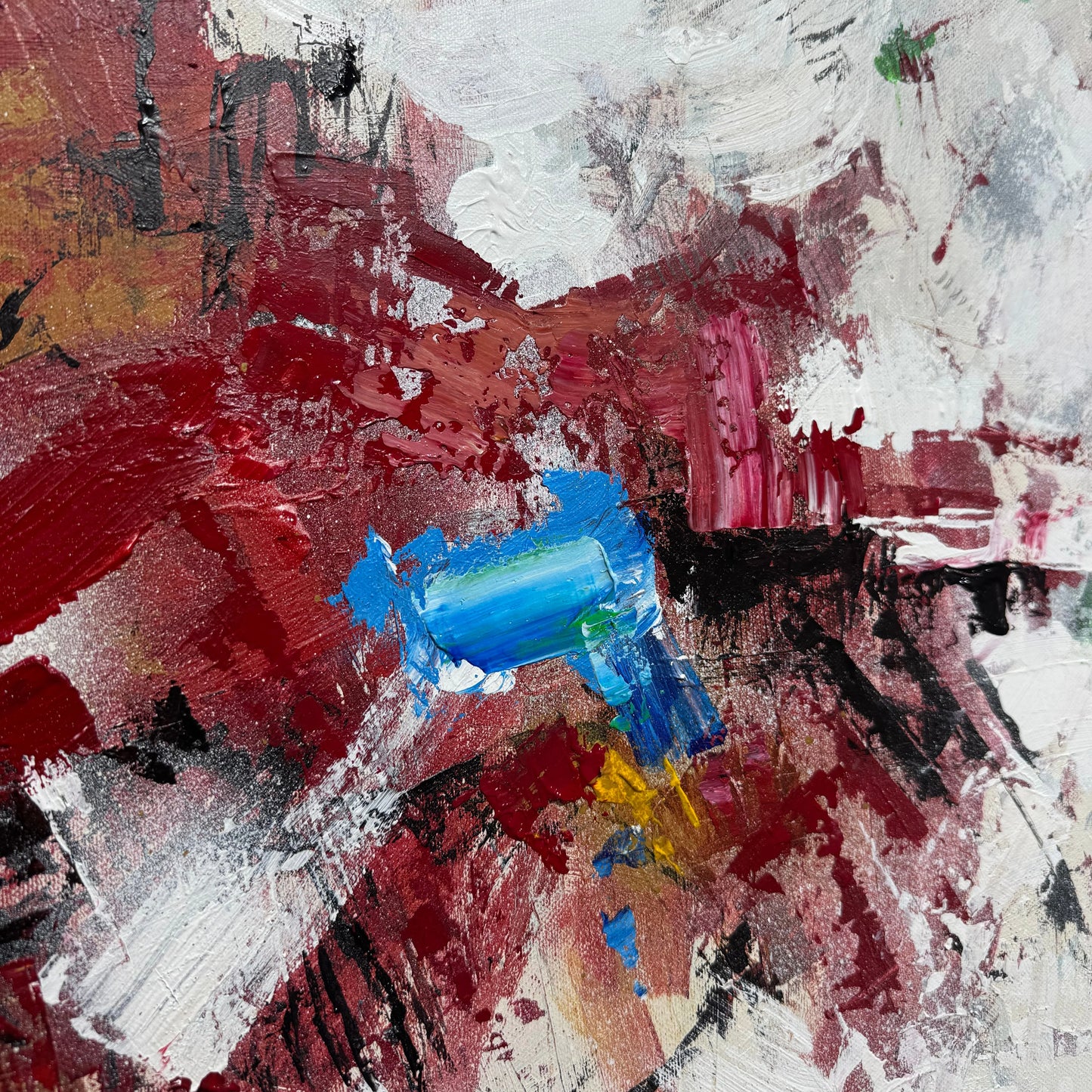 The image is an abstract painting with bold, expressive brushstrokes in red, white, and blue colors. The painting appears to be a dynamic and energetic composition, with a mix of thick and thin layers of paint.