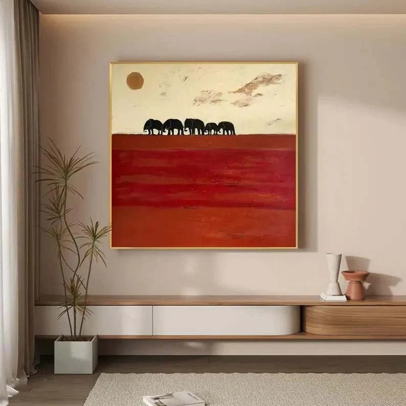 a large painting of elephants on a red background hanging on a wall in a modern living room.