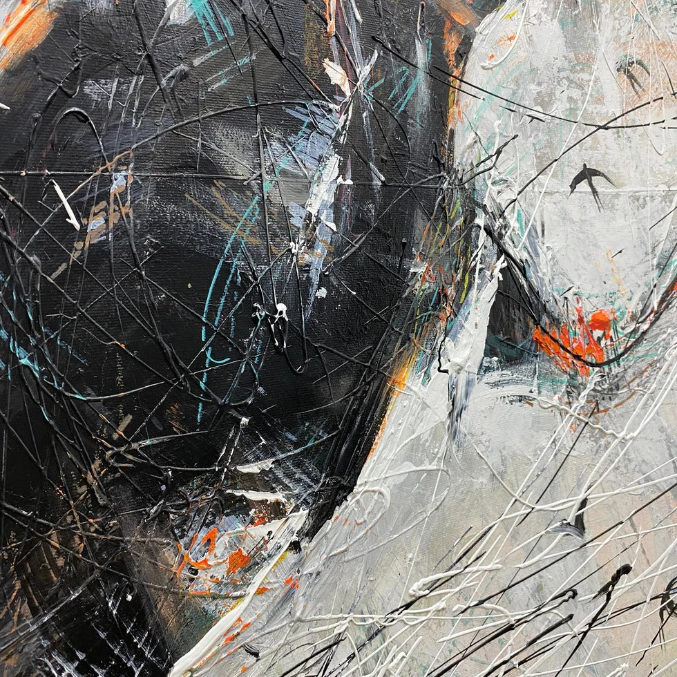 The image is an abstract painting with a mix of black, white, and orange colors. The painting has a chaotic and expressive style, with splashes of color and brushstrokes creating a sense of movement and energy.