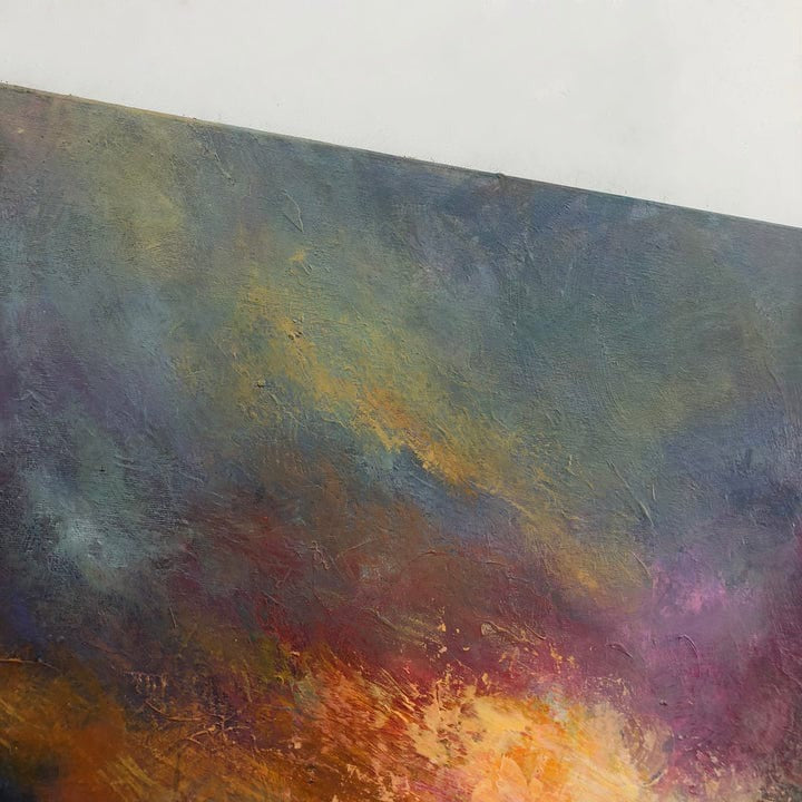 The image is an abstract painting with a vibrant mix of colors, including shades of blue, green, orange, and pink. The painting has a textured surface, giving it a dynamic and expressive appearance.