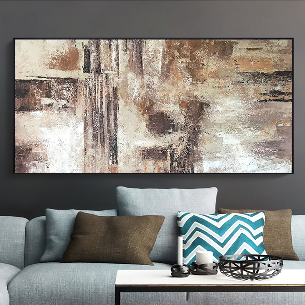 a living room with a couch and a painting on the wall