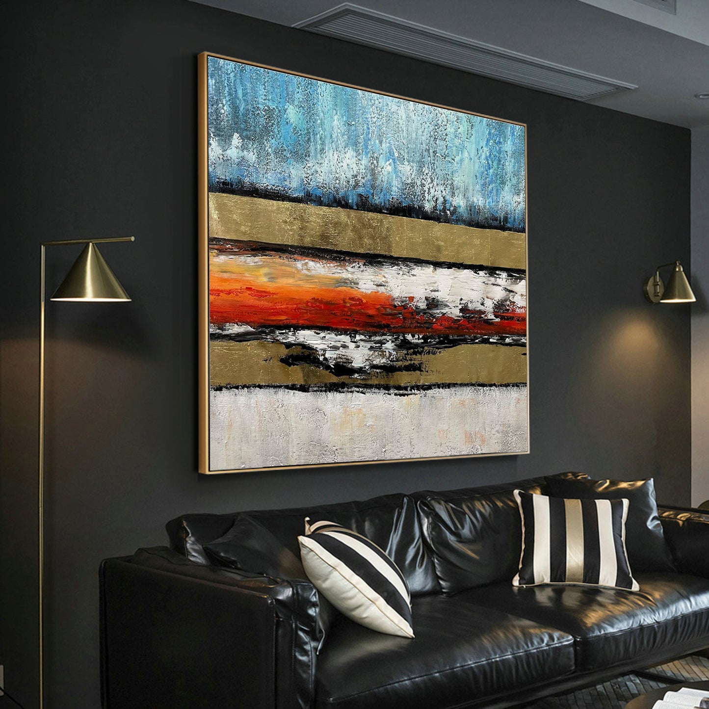 a living room with a couch and a painting on the wall