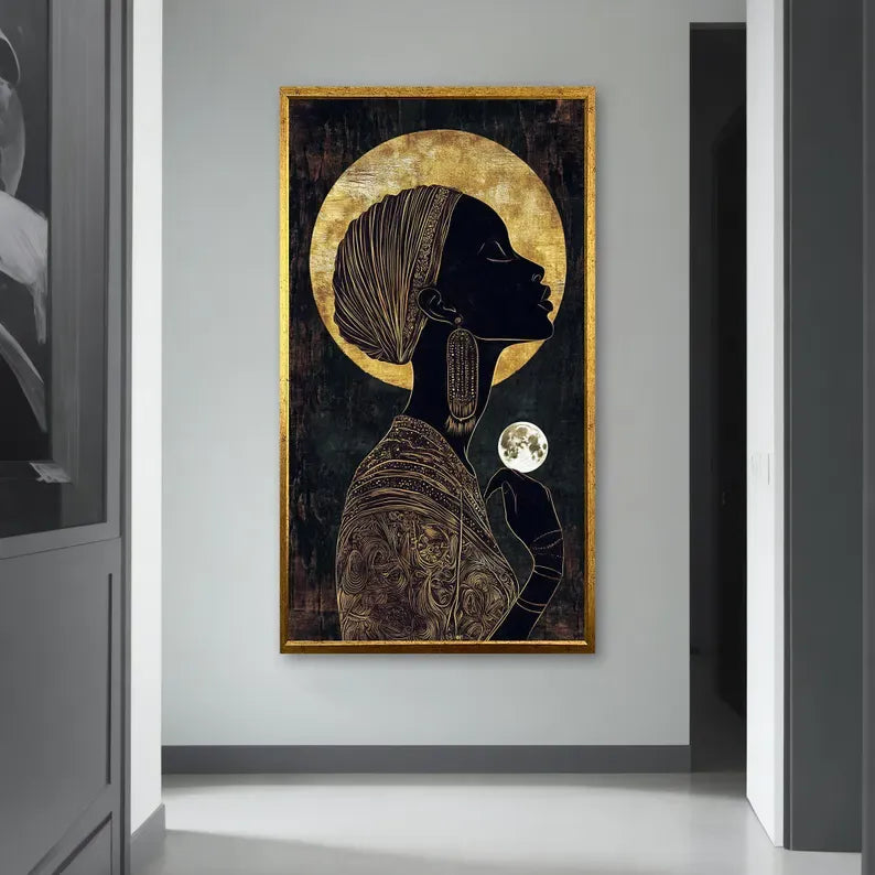 a large framed artwork depicting a woman with a headdress and a moon in her hand, hanging on a wall in a hallway.