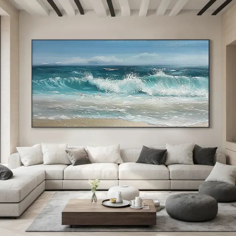 a large, white sectional sofa in a modern living room, with a large painting of a crashing ocean scene hanging on the wall above it.