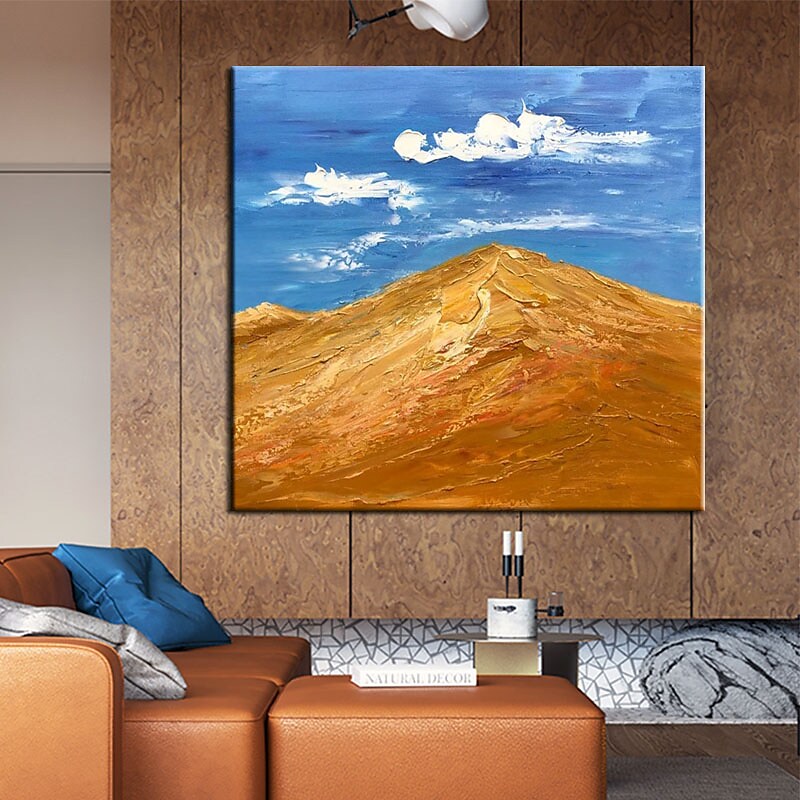 a living room with a couch and a painting on the wall