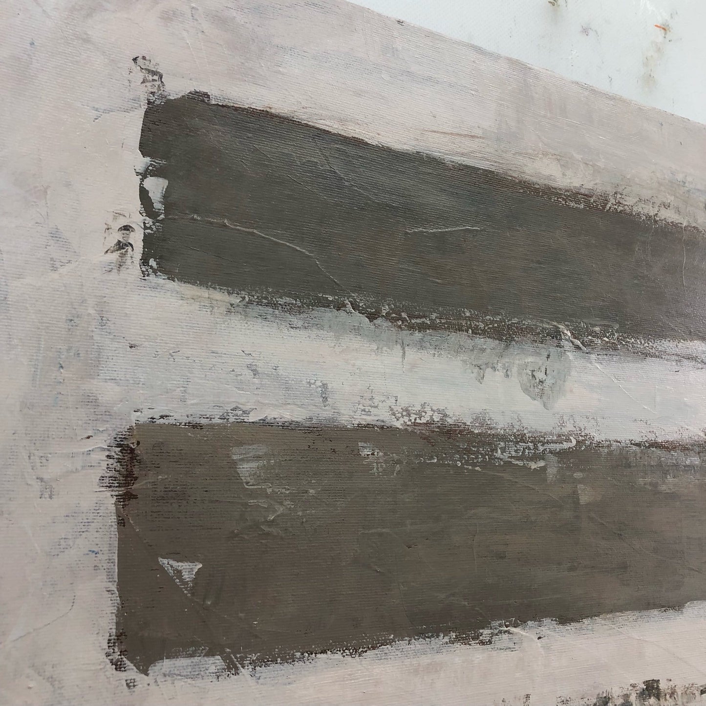 The image is a close-up of a painting with two horizontal stripes of varying shades of gray, creating a sense of depth and texture.