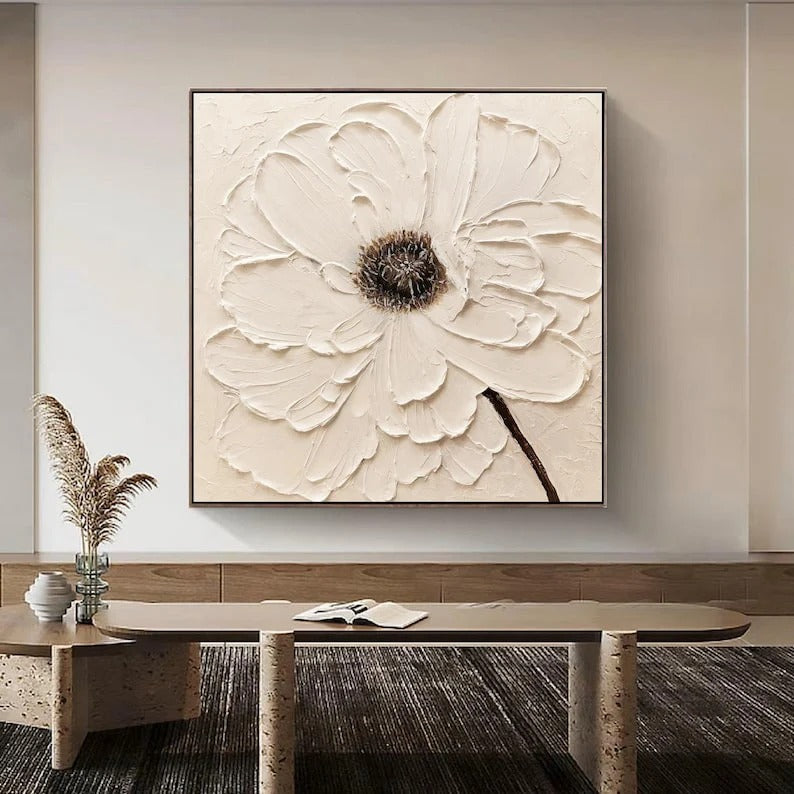 a large, white, floral-inspired painting hanging on a wall above a wooden coffee table.