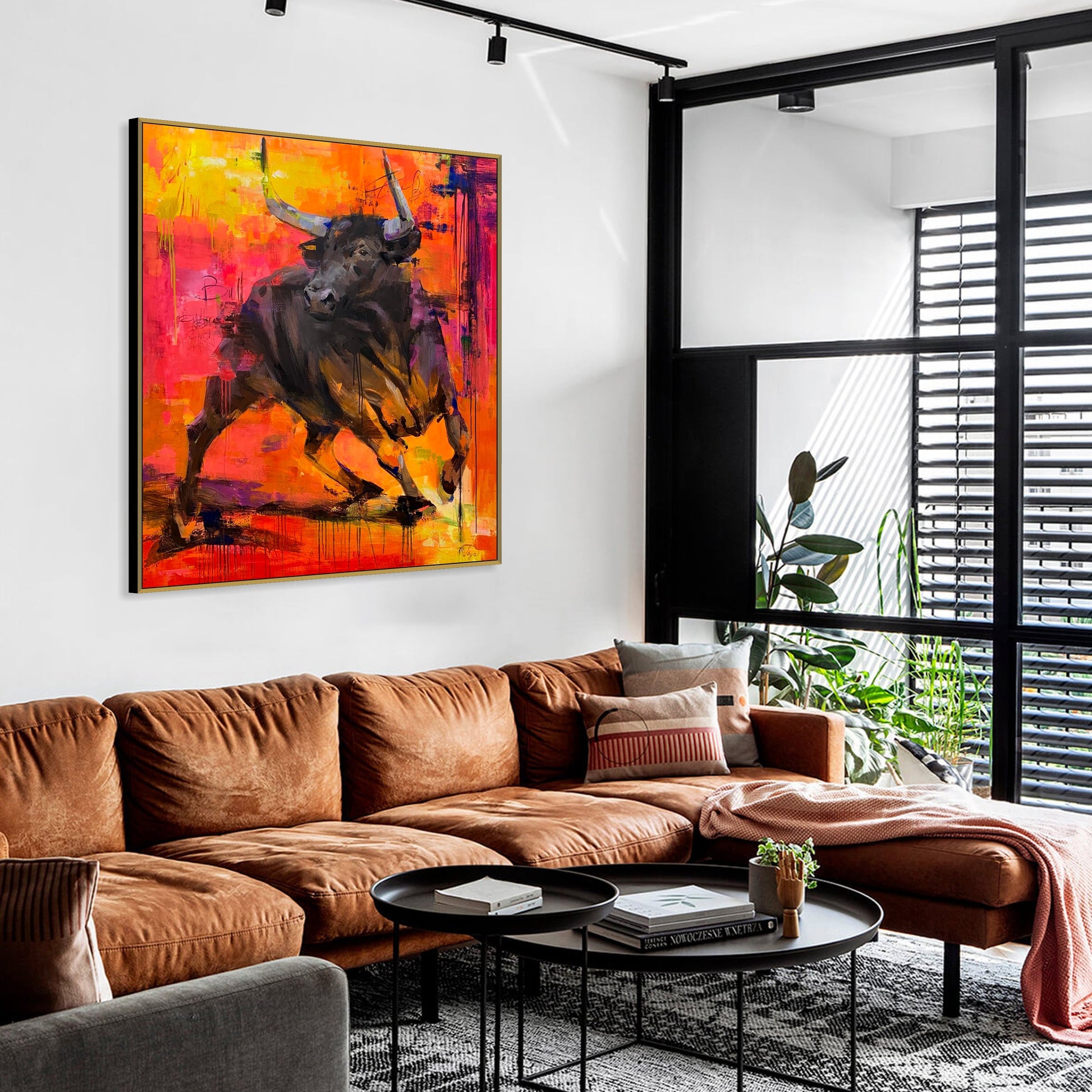 a living room filled with furniture and a painting on the wall