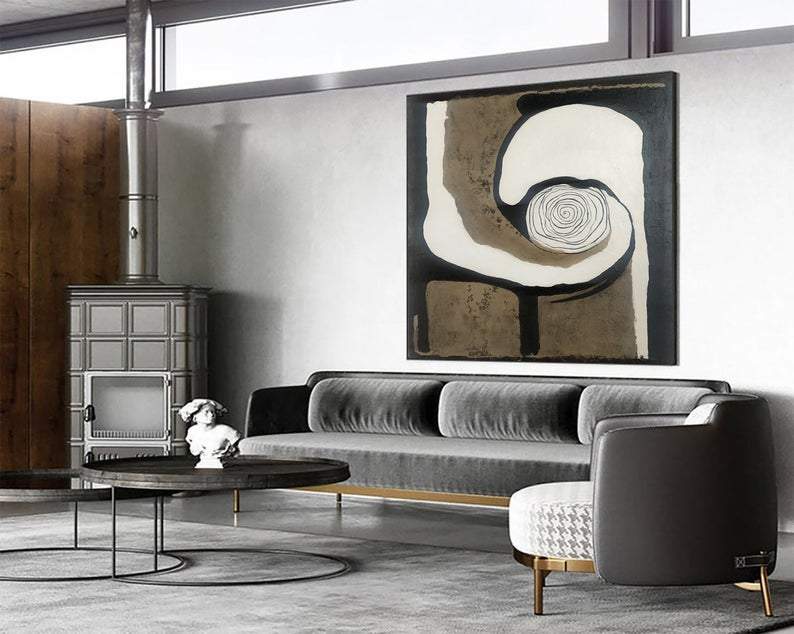 a living room filled with furniture and a painting on the wall