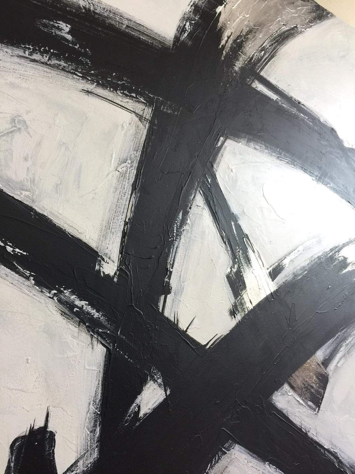 a painting with black and white paint on it