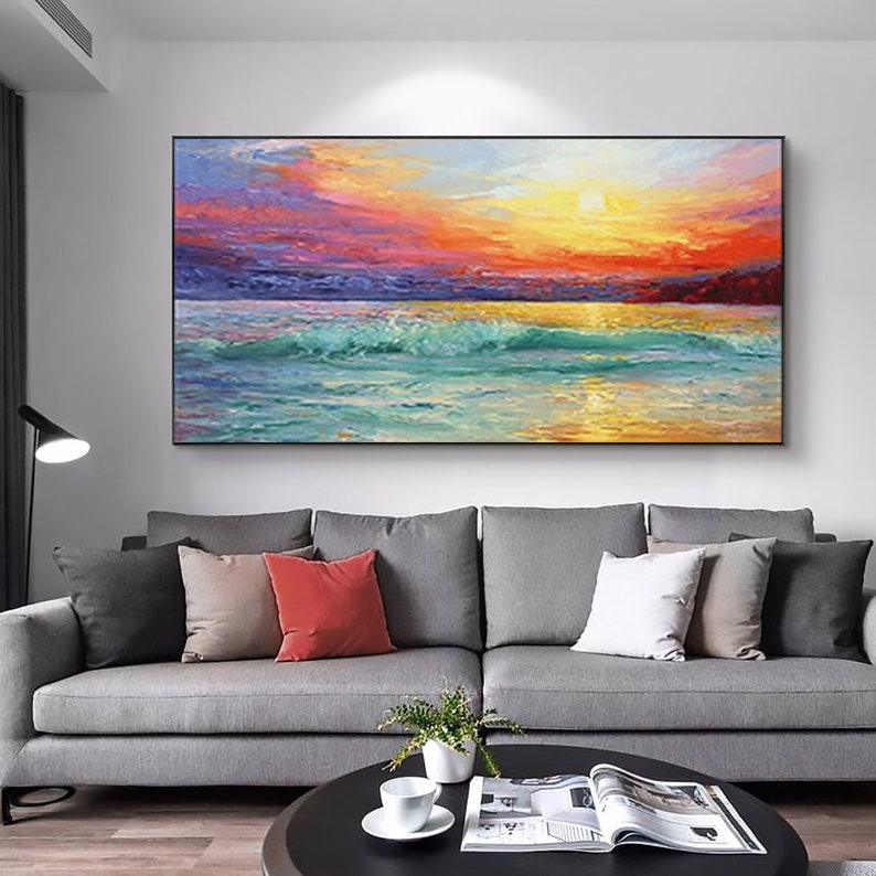 a living room with a couch and a painting on the wall