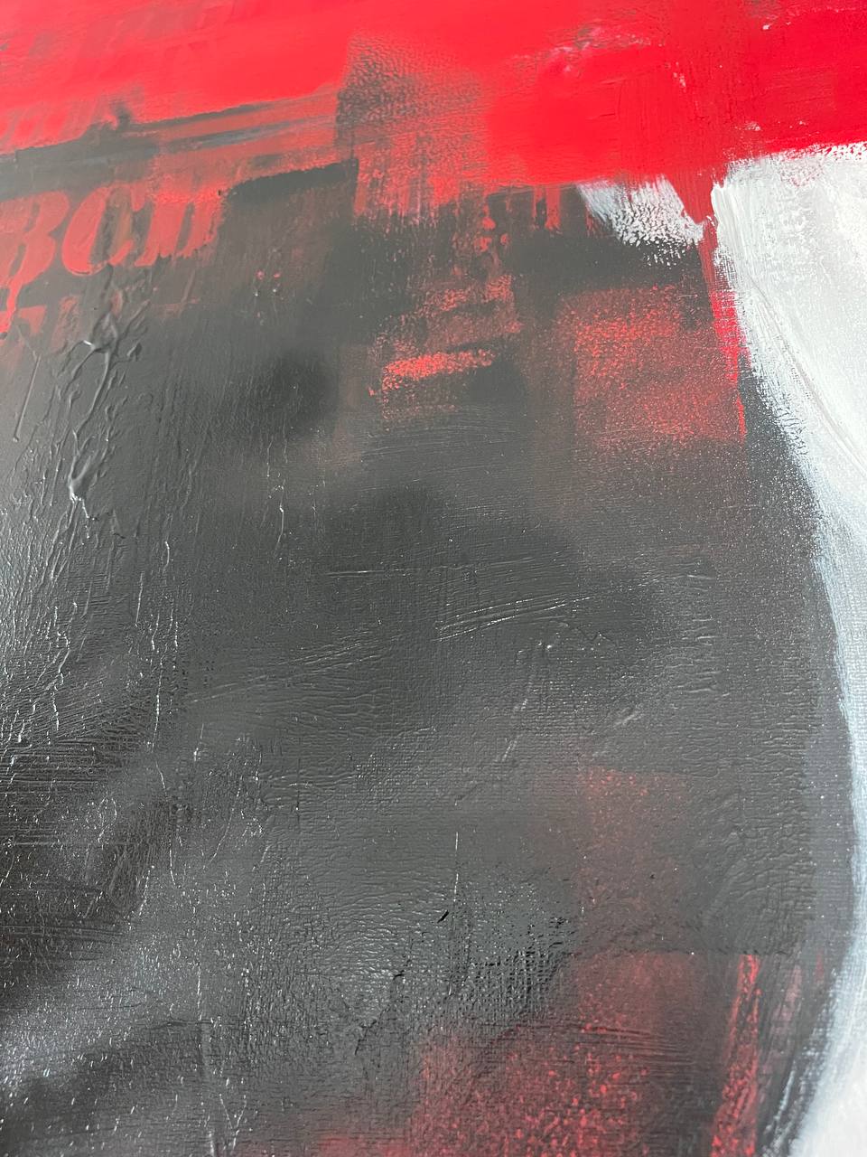 a close up of a red and black painting