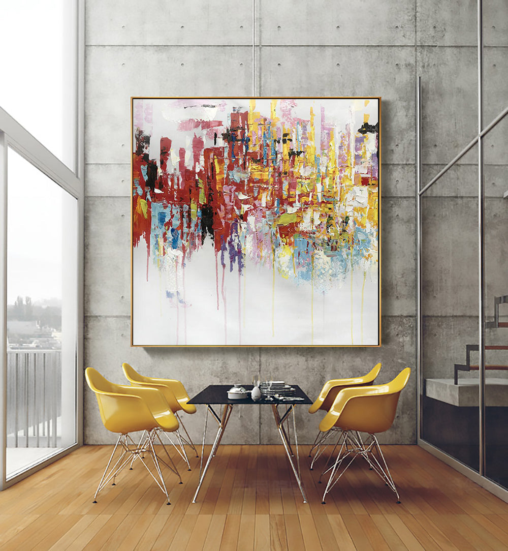 a painting hanging on a wall above a table