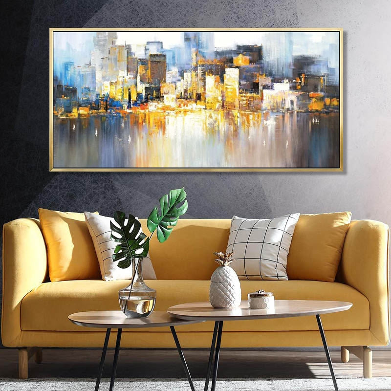 a living room with a yellow couch and a painting on the wall