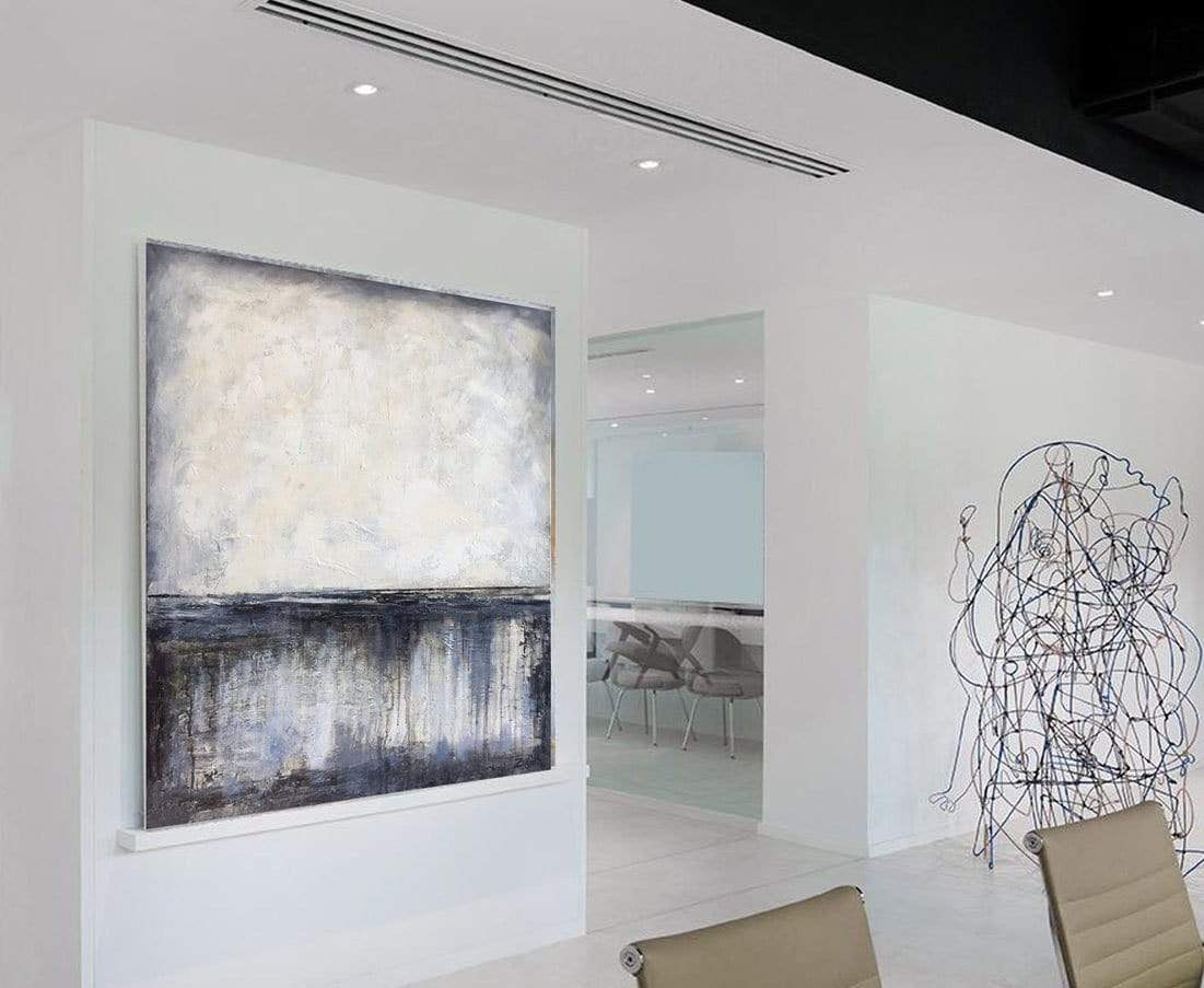 a large painting hanging in a white room