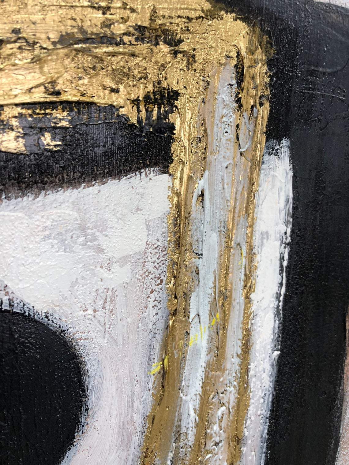 a close up of a black and gold painting