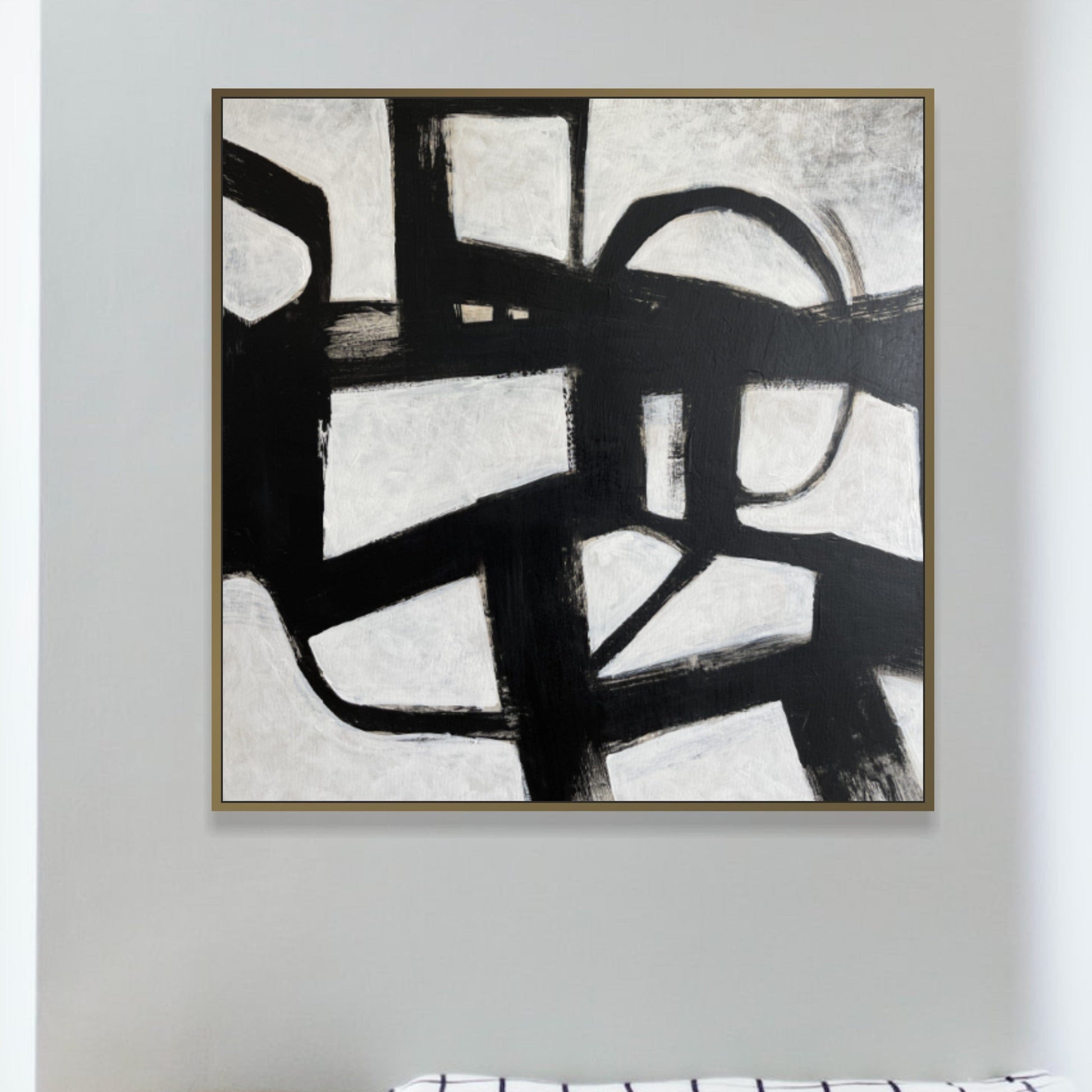 a black and white painting hanging on a wall