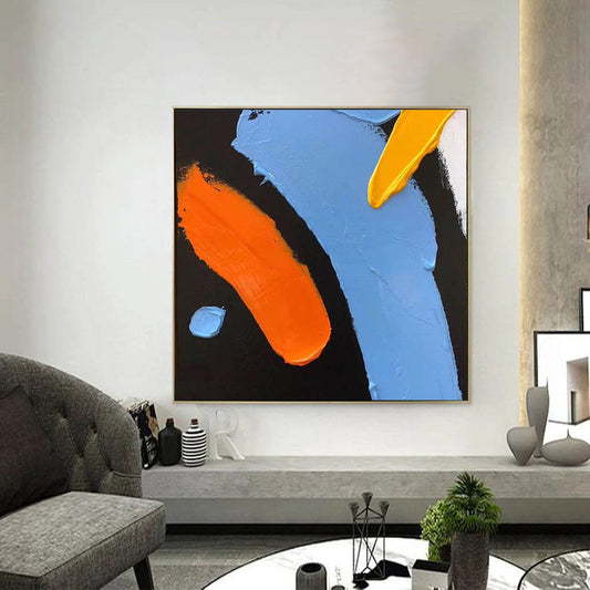 a living room filled with furniture and a painting on the wall