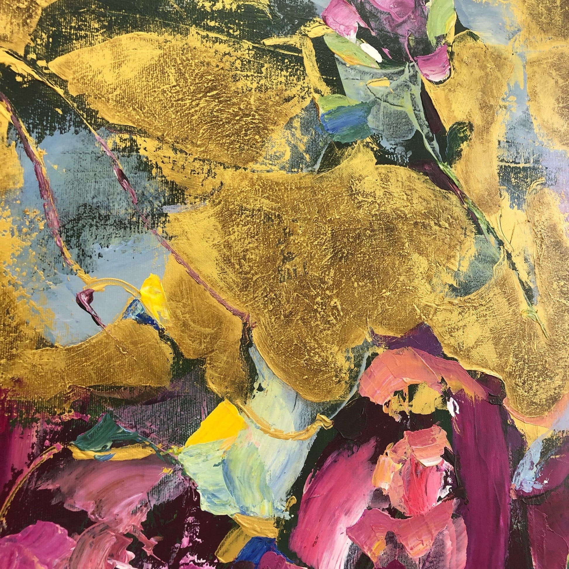 The image is an abstract painting with a vibrant mix of colors and textures, including gold, pink, blue, and green. The painting appears to be a dynamic and expressive piece of art, with a sense of movement and energy.