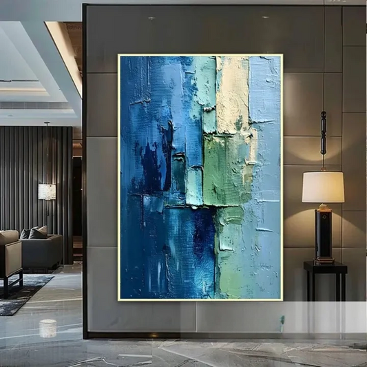 a large abstract painting with a blue and green color scheme, displayed on a wall in a modern living room setting.