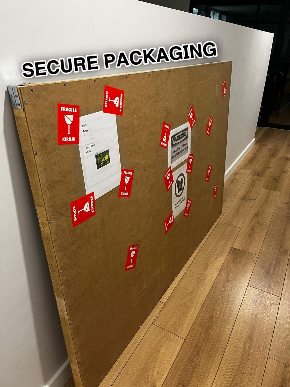 a cardboard box with some red stickers on it